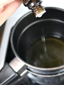 Adding essential oils to melted coconut oil and wax