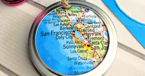 Map circle glued into a mason jar ring.