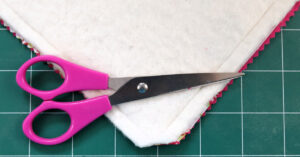 Clip corners of fabric and batting without snipping the stitching of your pot holder