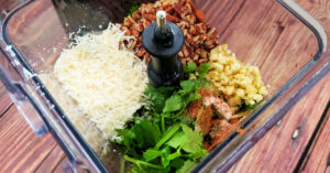 Cilantro, parmesan cheese, pecans, garlic, olive oil and spices in a blender pitcher.