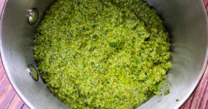 Cilantro pesto being warmed in a sauce pan.