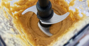 Hummus ingredients being combined in blender.