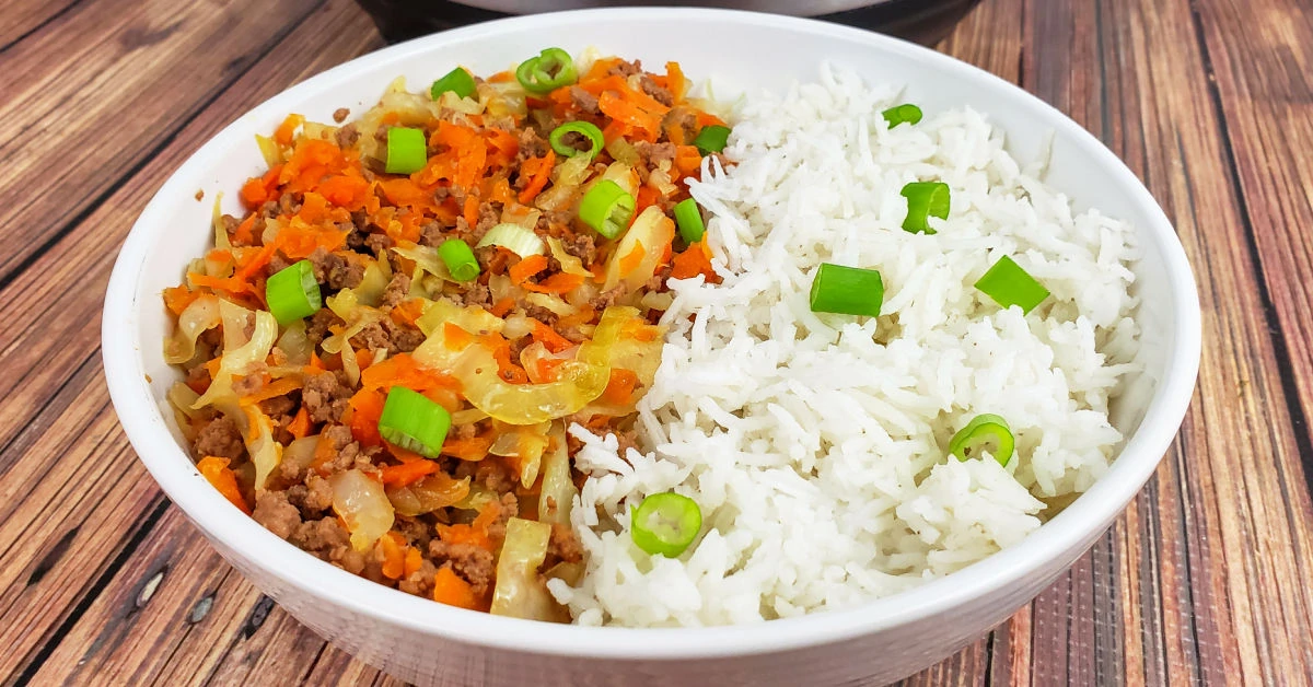 Shallow bowl of half egg roll in a bowl and half basmati rice.